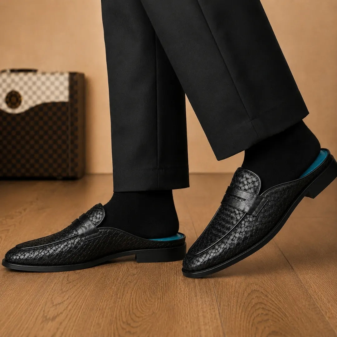 Melodiapelle Madana Mule in black woven leather worn with trousers, on-feet shot