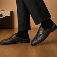 Melodiapelle Madana Mule in dark brown woven leather worn with trousers, on-feet shot