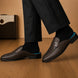 Melodiapelle Madana Mule in dark brown woven leather worn with trousers, on-feet shot