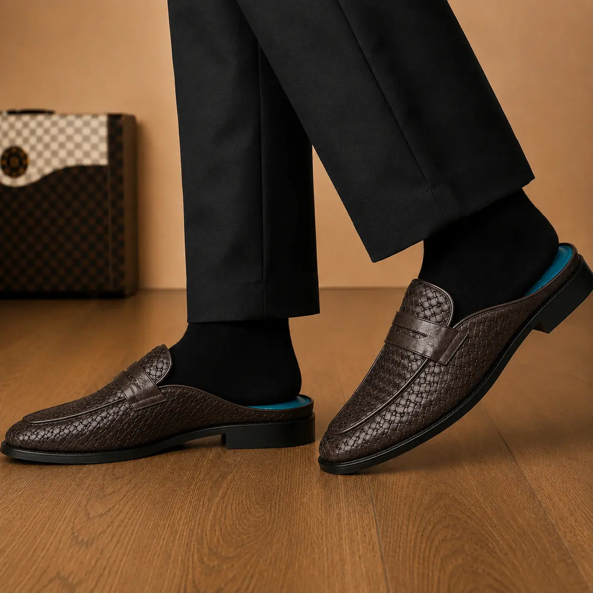 Melodiapelle Madana Mule in dark brown woven leather worn with trousers, on-feet shot