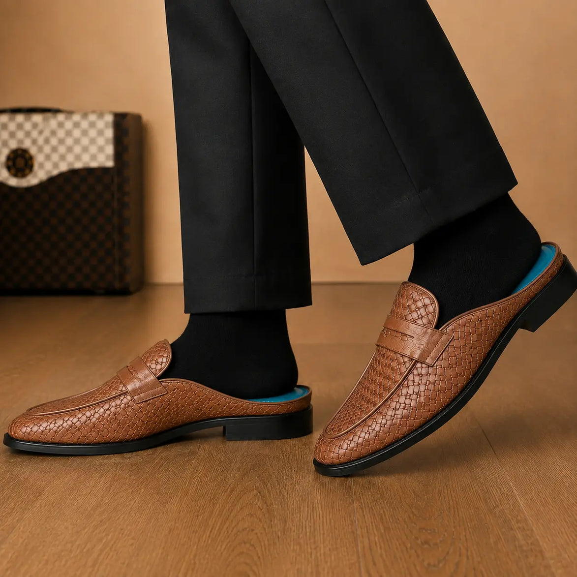 Melodiapelle Madana Mule in tan woven leather worn with trousers, on-feet shot