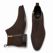 Brown suede zip boot, three-quarter angle showing side zip, heel and sole detailing
