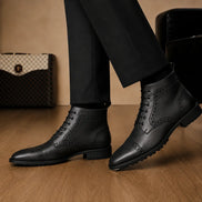 Melodiapelle Madison Combat Boot in black leather worn with trousers, on-feet shot