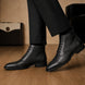 Melodiapelle Madison Combat Boot in black leather worn with trousers, on-feet shot