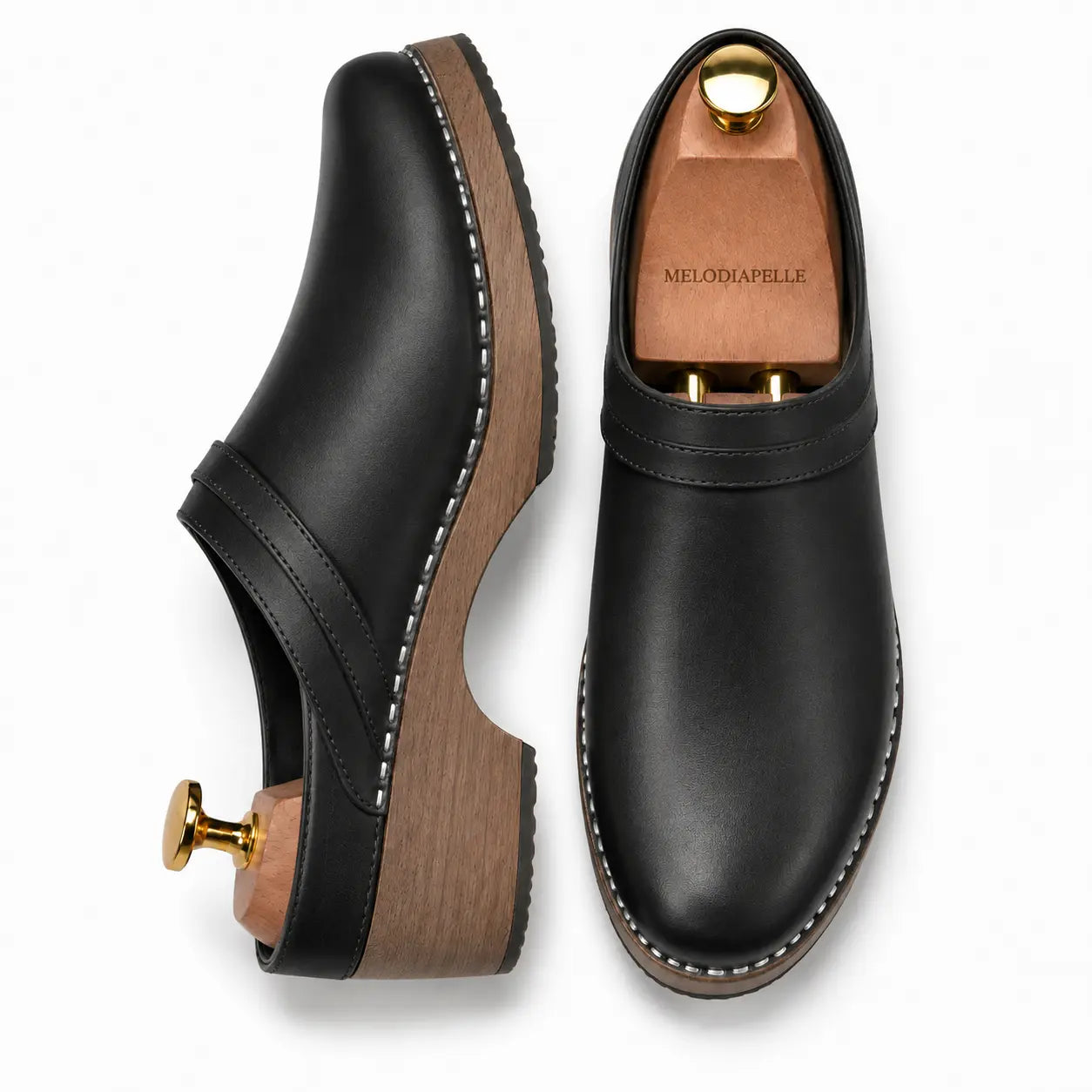 Black leather backless mule, three-quarter angle showing heel and sole detailing