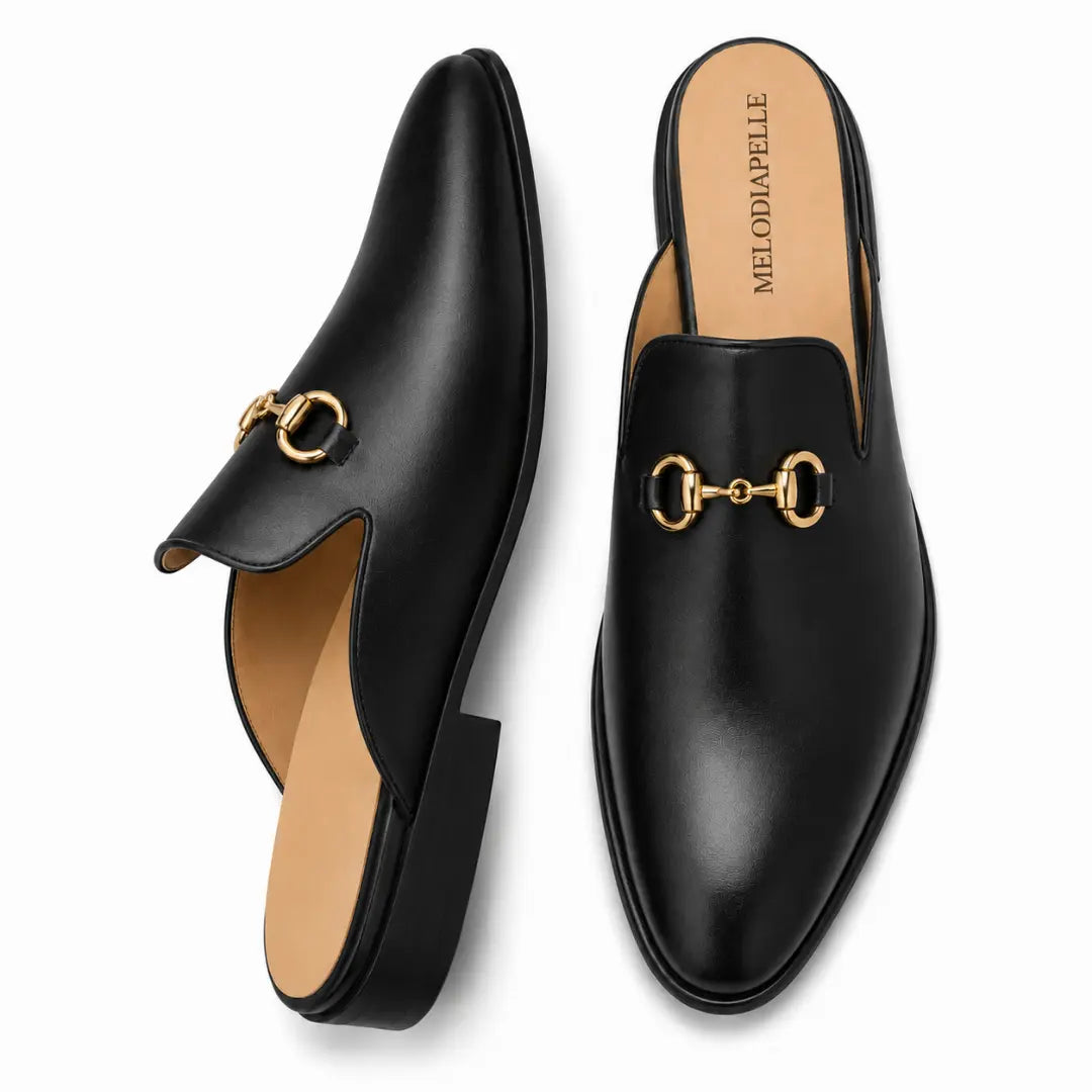 Black leather horsebit mule, three-quarter angle showing buckle and heel