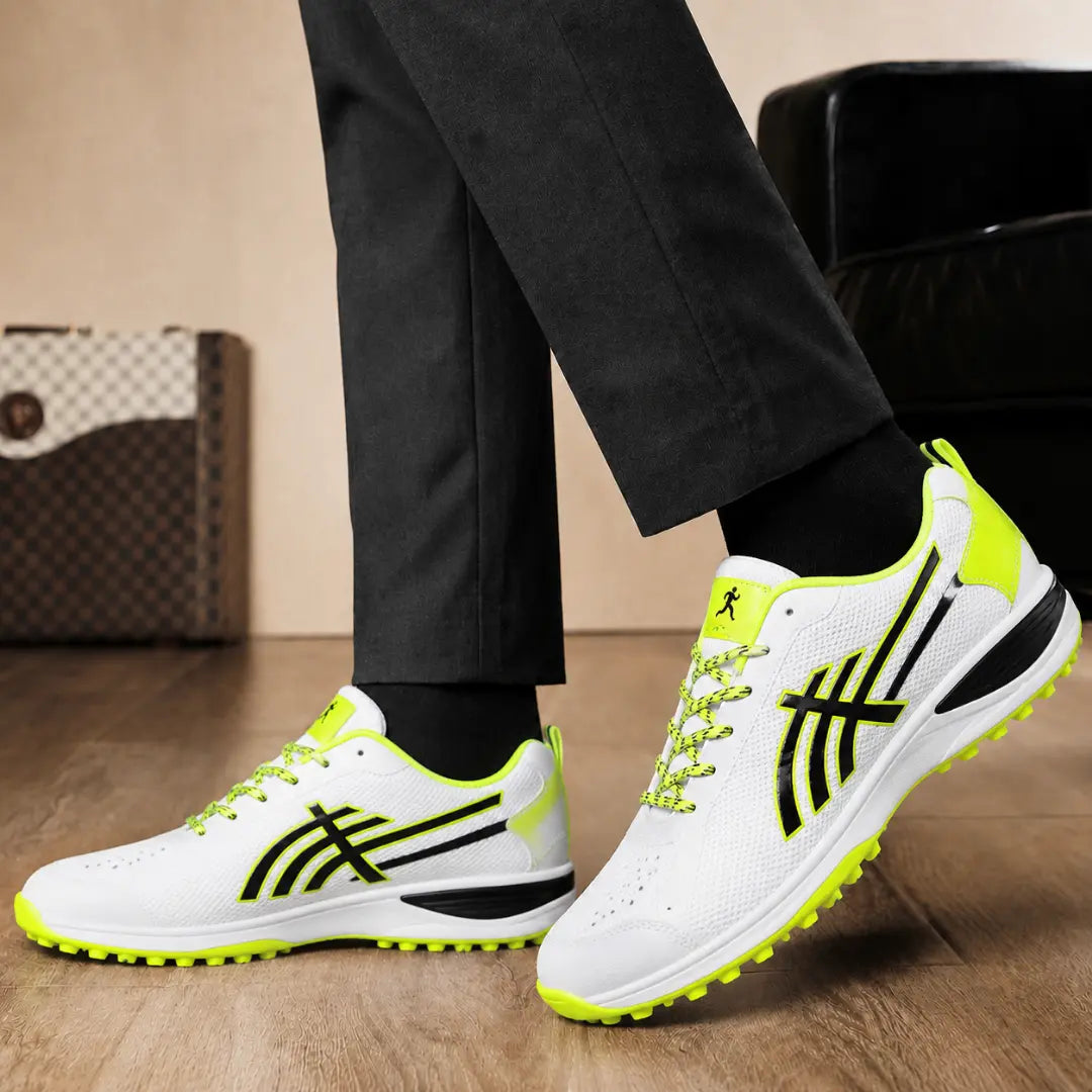 Melodiapelle Madras Cricket Shoe in white and neon yellow worn with trousers, on-feet shot