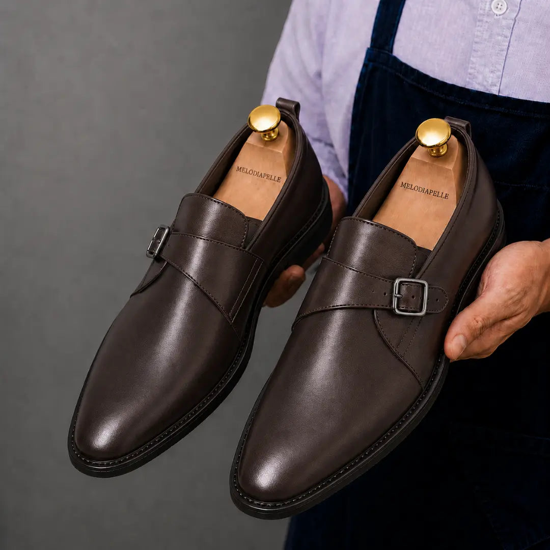 Man holding a pair of Melodiapelle Madrid Single Monk Strap shoes in dark chocolate leather, close-up