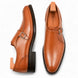 Tan leather single monk strap shoe, three-quarter angle showing buckle and heel