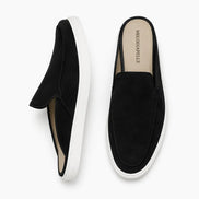 Black suede mule with white sneaker-sole, three-quarter angle showing heel and sole detailing