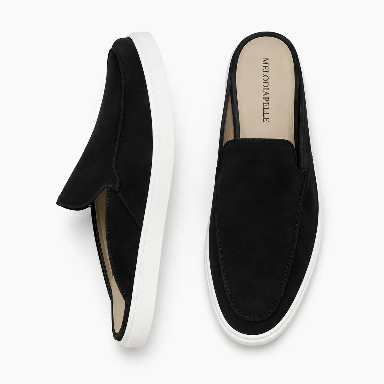 Black suede mule with white sneaker-sole, three-quarter angle showing heel and sole detailing