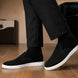 Melodiapelle Madurai Mule in black suede worn with trousers, on-feet shot