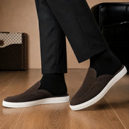 Melodiapelle Madurai Mule in dark brown suede worn with trousers, on-feet shot