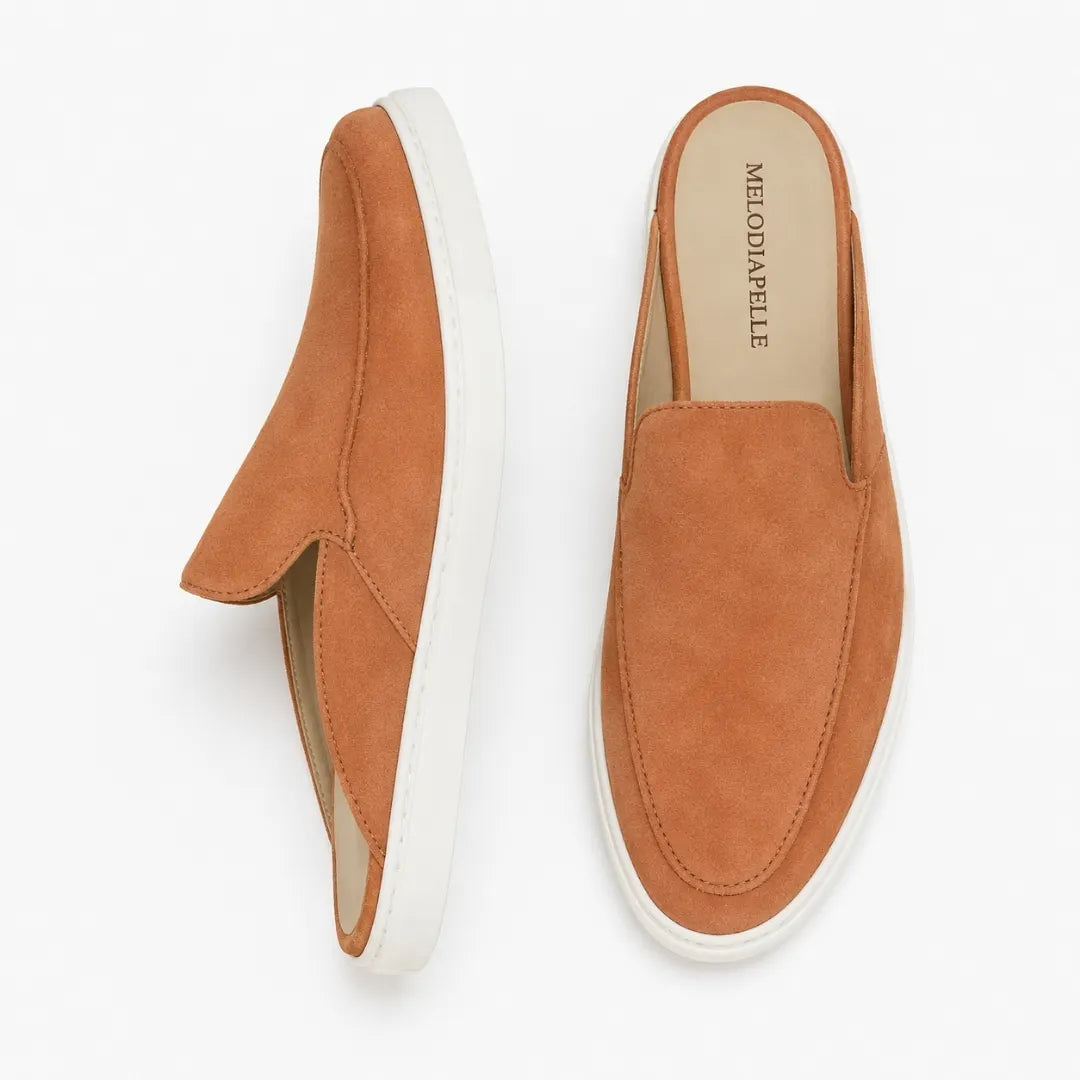 Rust tan suede mule with white sneaker-sole, three-quarter angle showing heel and sole detailing