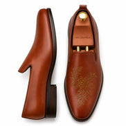 Cognac tan leather opera loafer with embroidery, three-quarter angle showing heel and slip-on silhouette