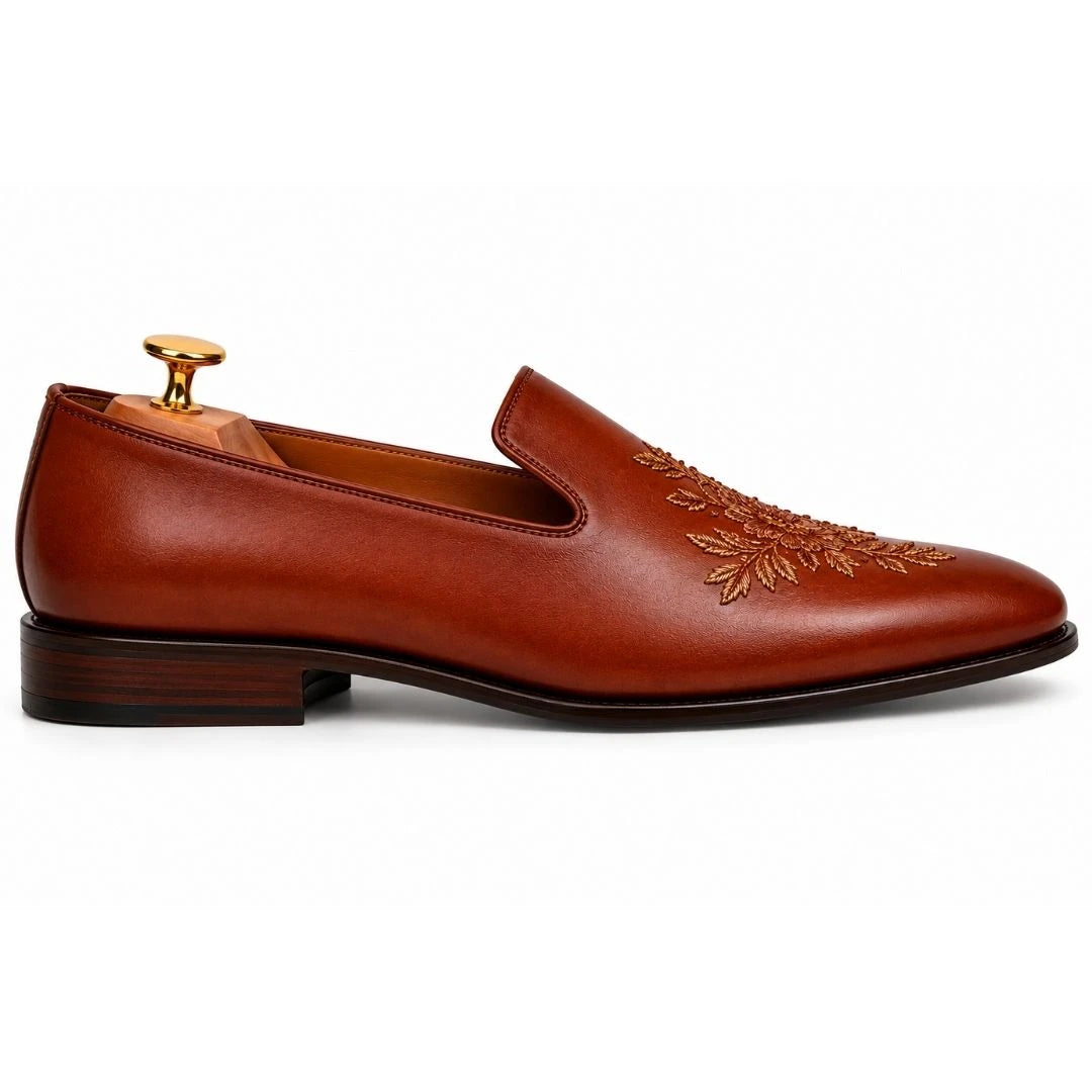 Side profile of the Maestro Embroidered Opera Loafer in cognac tan leather on white background