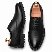 Black leather plain-toe Derby, three-quarter angle showing heel and sole detailing