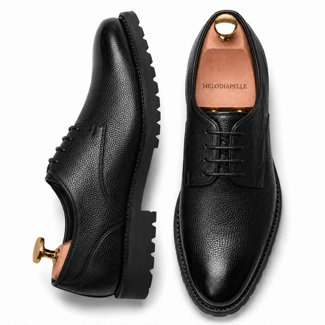 Black leather plain-toe Derby, three-quarter angle showing heel and sole detailing