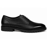 Side profile of the Magnum Derby Shoe in black leather on white background