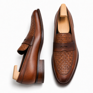 Cognac tan leather woven penny loafer, three-quarter angle showing heel and woven detailing