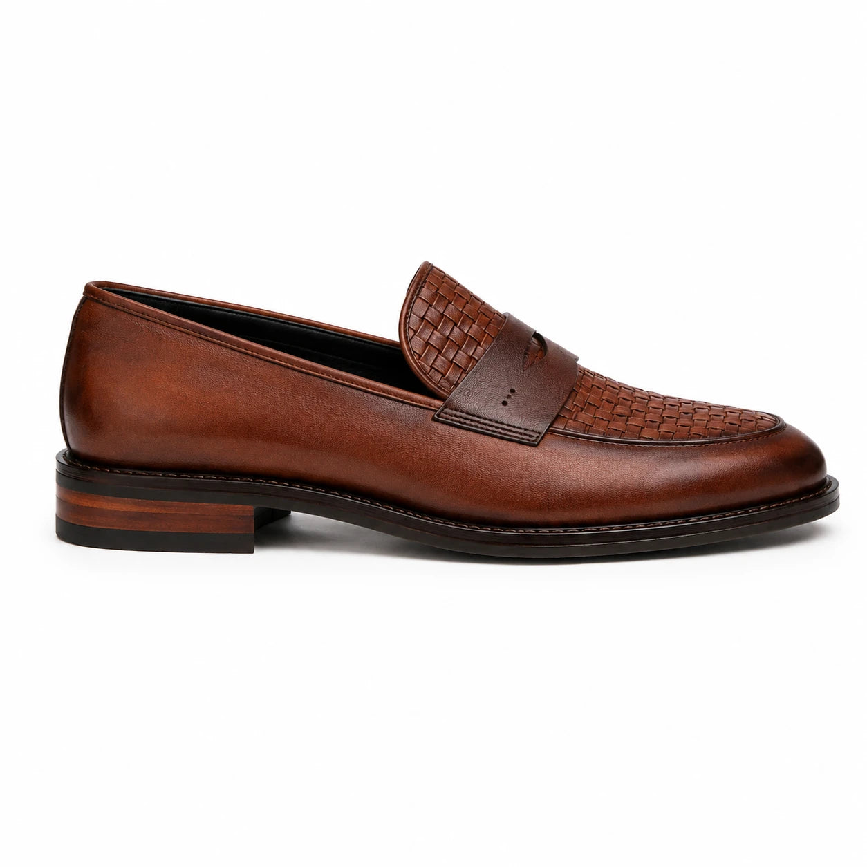 Side profile of the Maison Woven Penny Loafer in cognac tan leather on white background