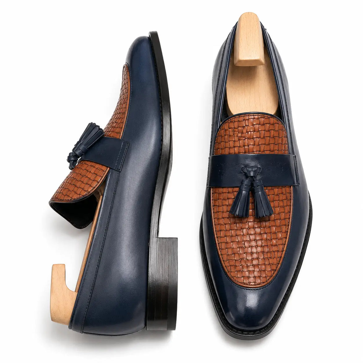 Midnight navy and tan woven leather penny loafer, three-quarter angle showing tassel and heel detailing