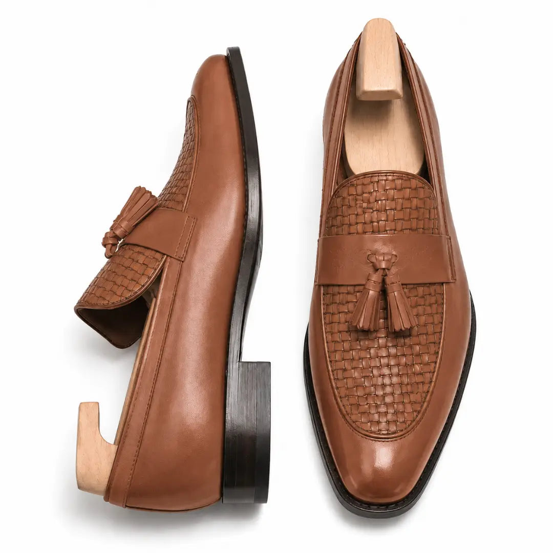 Tan woven leather penny loafer, three-quarter angle showing tassel and heel detailing