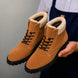 Man holding a pair of Melodiapelle Malabar Shearling Winter Boots in camel suede, close-up