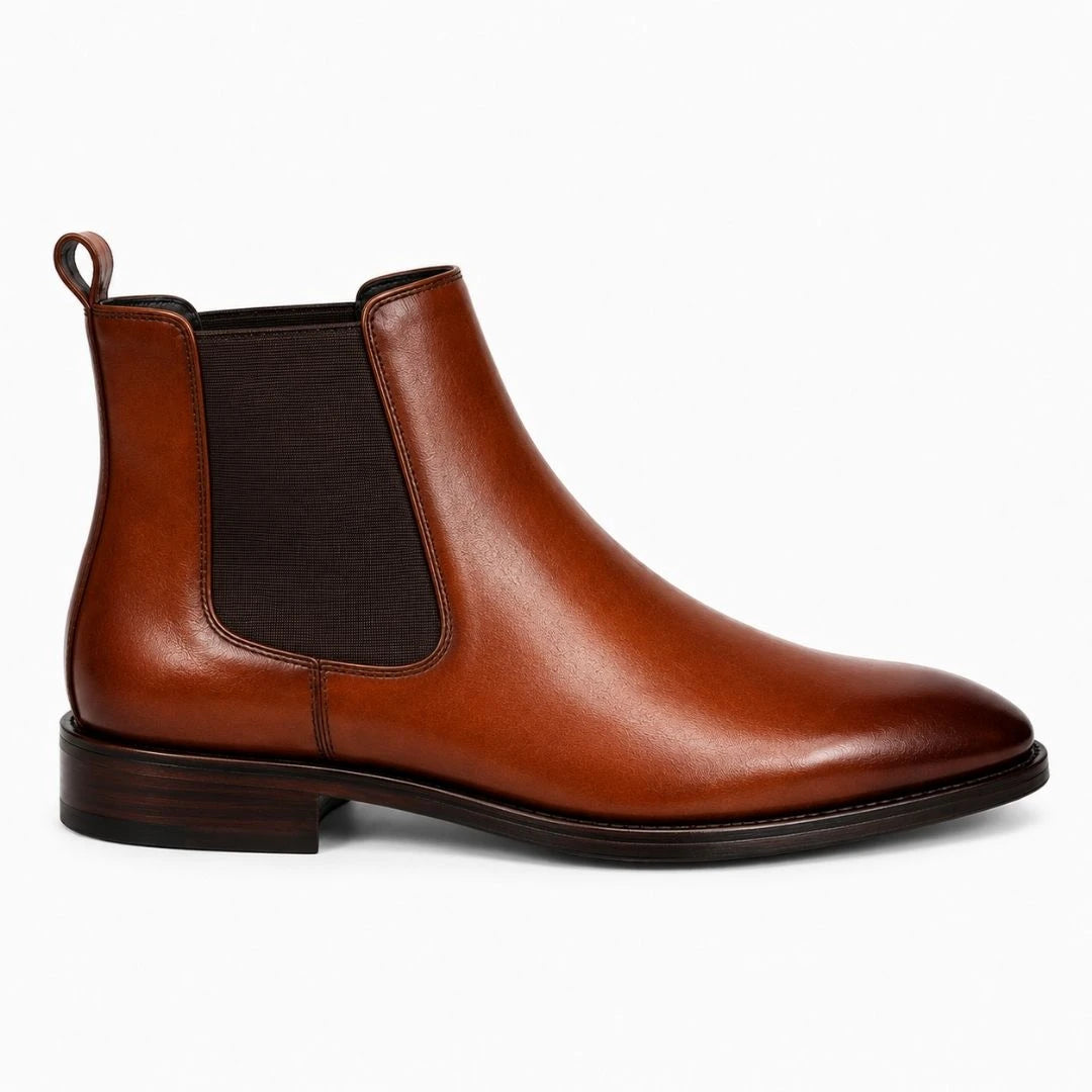 Side profile of the Malacca Chelsea Boot in cognac tan leather on white background