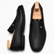 Black leather driving loafer, three-quarter angle showing moc-toe stitching and heel