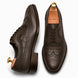 Brown leather wingtip Derby, three-quarter angle showing croc-embossed panel and heel