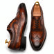 Croc-panel wingtip Derby in cognac and dark brown leather, three-quarter angle showing heel and brogue detailing