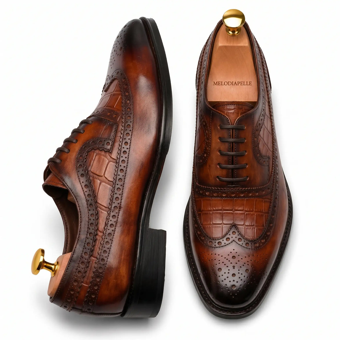 Croc-panel wingtip Derby in cognac and dark brown leather, three-quarter angle showing heel and brogue detailing