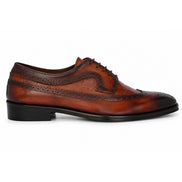 Side profile of the Malcomb Croc-Panel Wingtip Derby in cognac and dark brown leather on white background