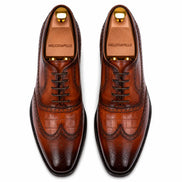 Melodiapelle Malcomb Croc-Panel Wingtip Derby in cognac and dark brown leather, pair top-down view, handcrafted in Agra