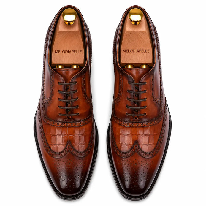 Melodiapelle Malcomb Croc-Panel Wingtip Derby in cognac and dark brown leather, pair top-down view, handcrafted in Agra