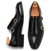 Nero black leather double monk strap shoe, three-quarter angle showing buckles and heel