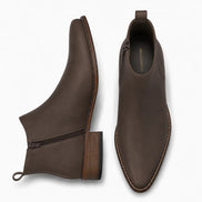 Dark brown leather ankle boot, three-quarter angle showing side zip and heel detailing