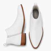 Pearl white leather ankle boot, three-quarter angle showing side zip and heel detailing