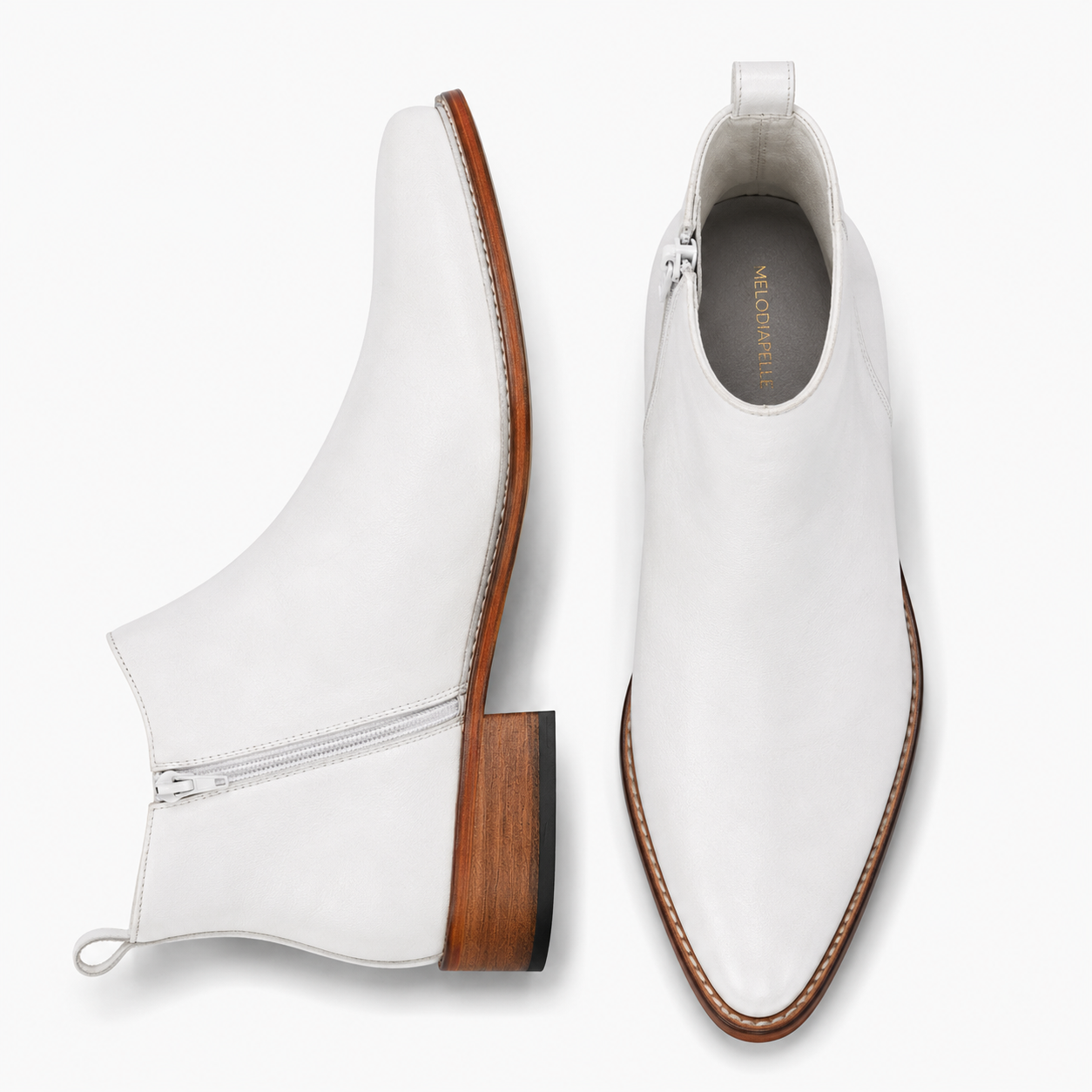 Pearl white leather ankle boot, three-quarter angle showing side zip and heel detailing