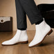 Melodiapelle Malone Zip Ankle Boot in pearl white leather worn with trousers, on-feet shot