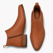 Tan leather ankle boot, three-quarter angle showing side zip and heel detailing