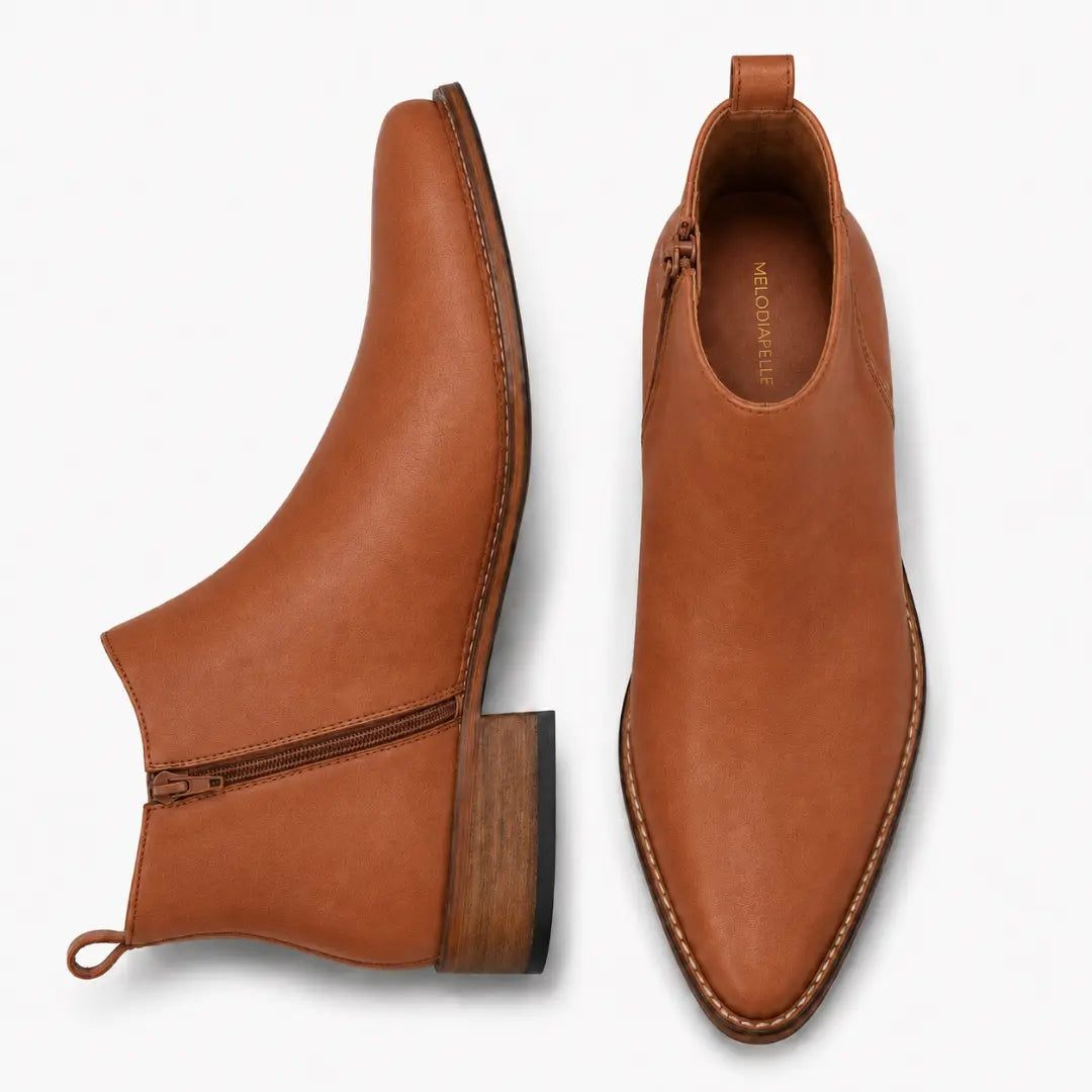 Tan leather ankle boot, three-quarter angle showing side zip and heel detailing