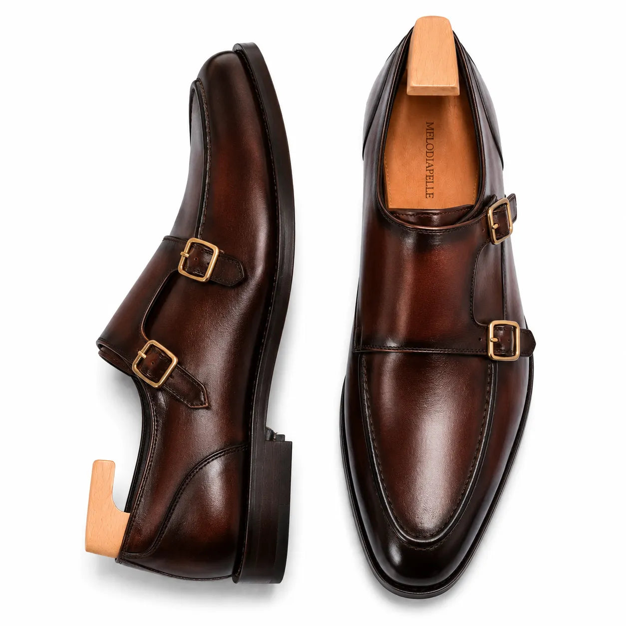 Dark mahogany leather double monk strap shoe, three-quarter angle showing buckles and heel