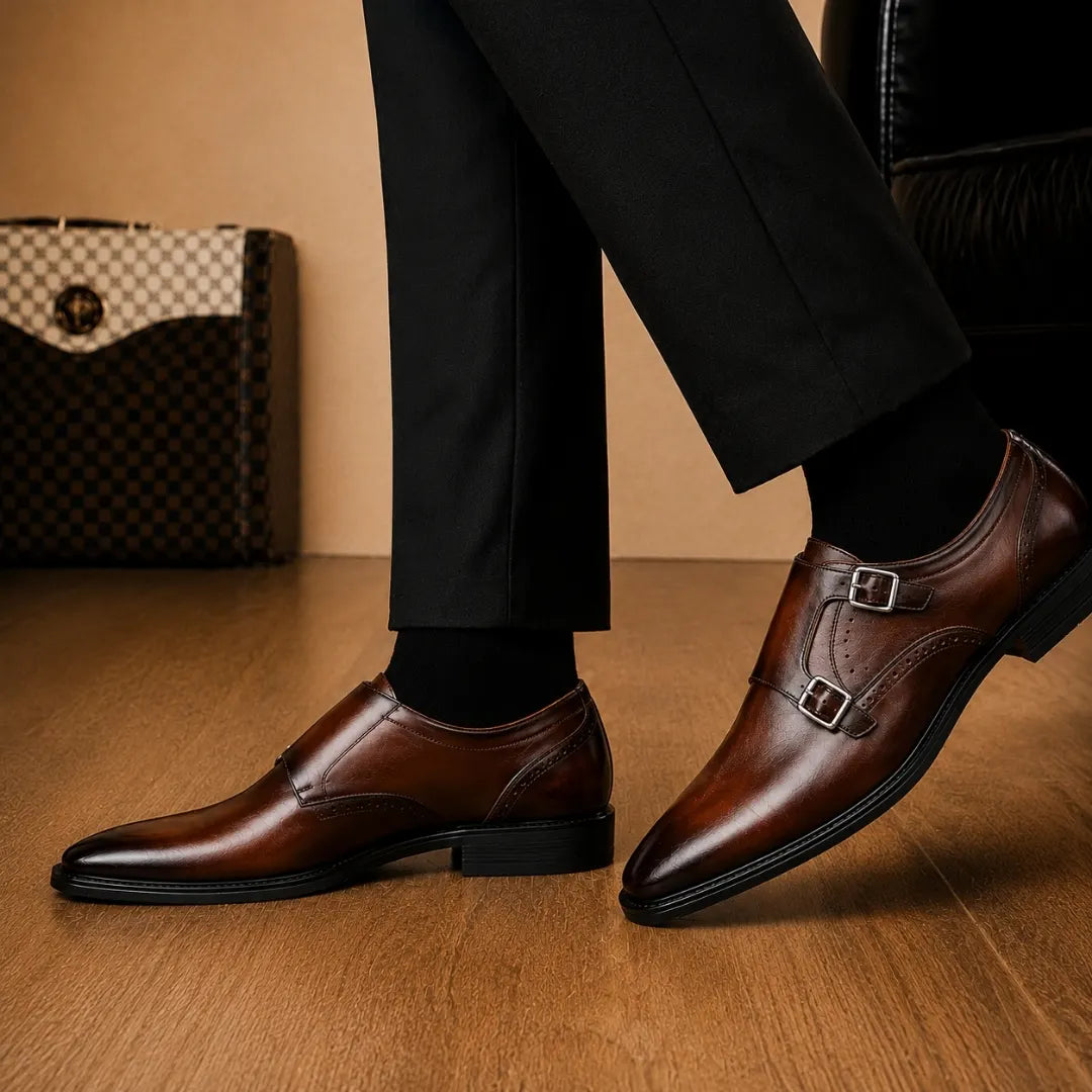 Man holding a pair of Melodiapelle Manchester Monk Strap shoes in burgundy leather, close-up