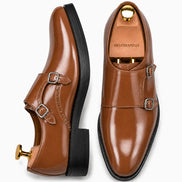 Tan leather double monk strap shoe, three-quarter angle showing buckles and heel