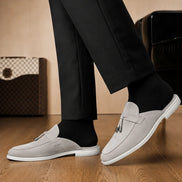 Melodiapelle Mandelli Mule in light grey suede worn with trousers, on-feet shot