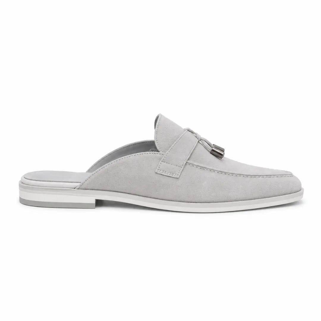 Side profile of the Mandelli Mule in light grey suede on white background