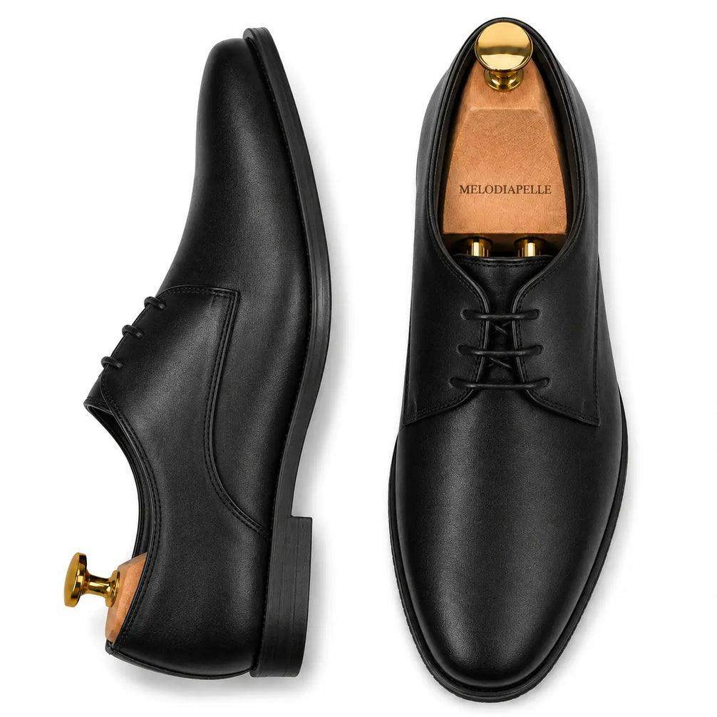 Black leather plain-toe Derby, three-quarter angle showing heel and clean upper