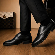 Melodiapelle Mangrove Plain Derby in black leather worn with formal trousers, on-feet shot